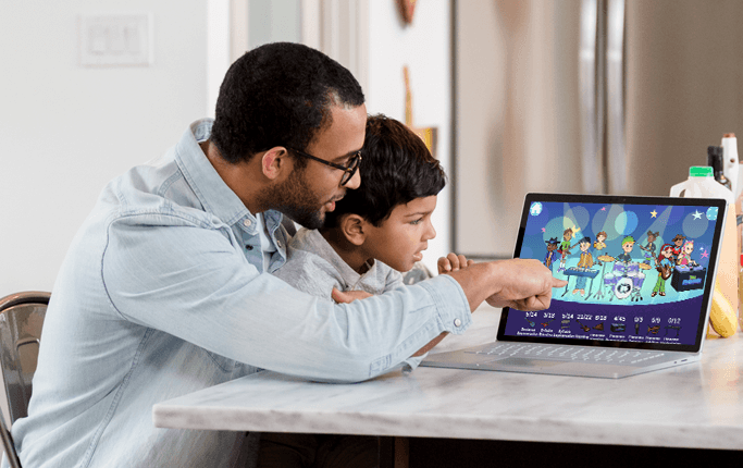 A parent and child sitting together at home, playing the phonemic awareness sound-blending missions on the HearBuilder platform.